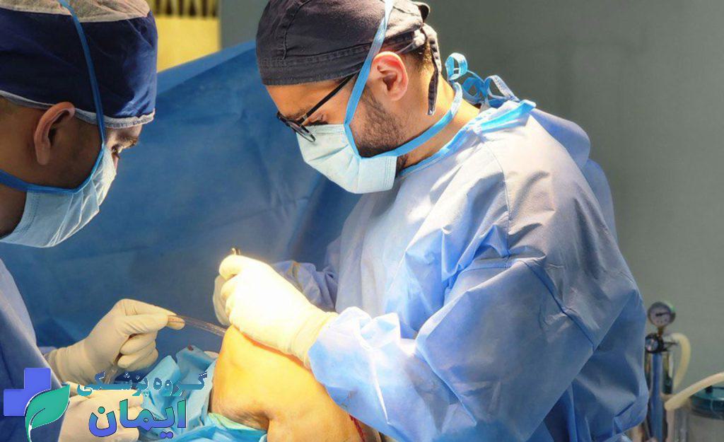 متخصص درد زانو در حال جراحی زانوی بیمار متخصص درد زانو در حال جراحی زانوی بیمار