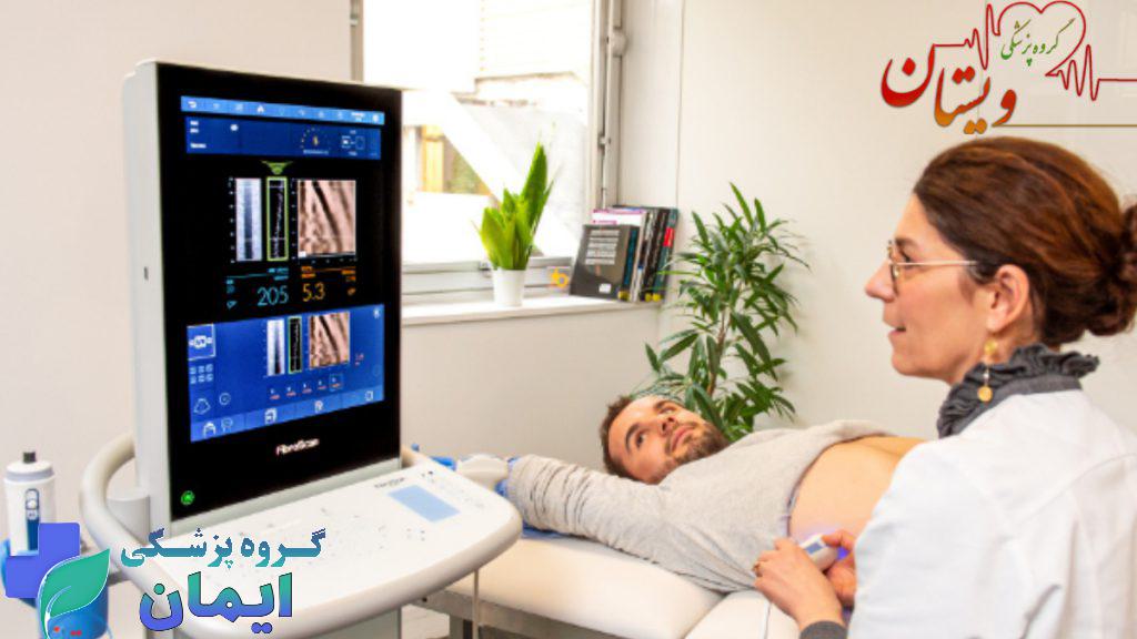 پزشک در حال مشاهده نتایج فیبرواسکن کبد بیمار در مانیتور مخصوص